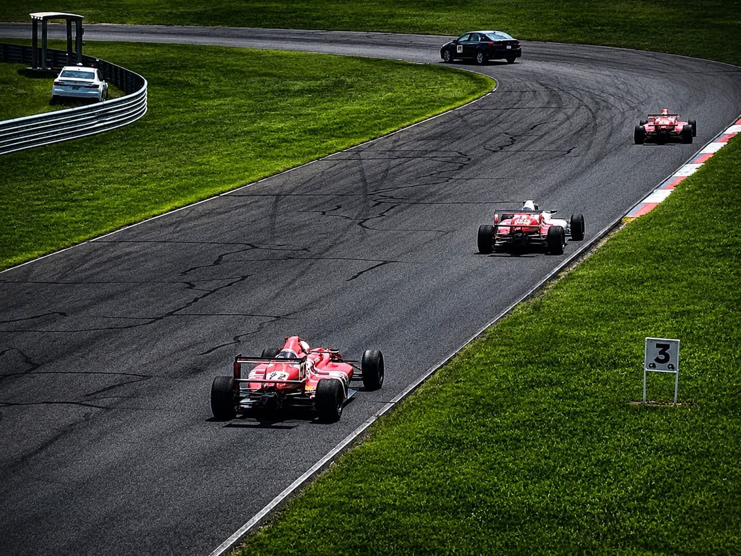 Multiple formula cars running on track